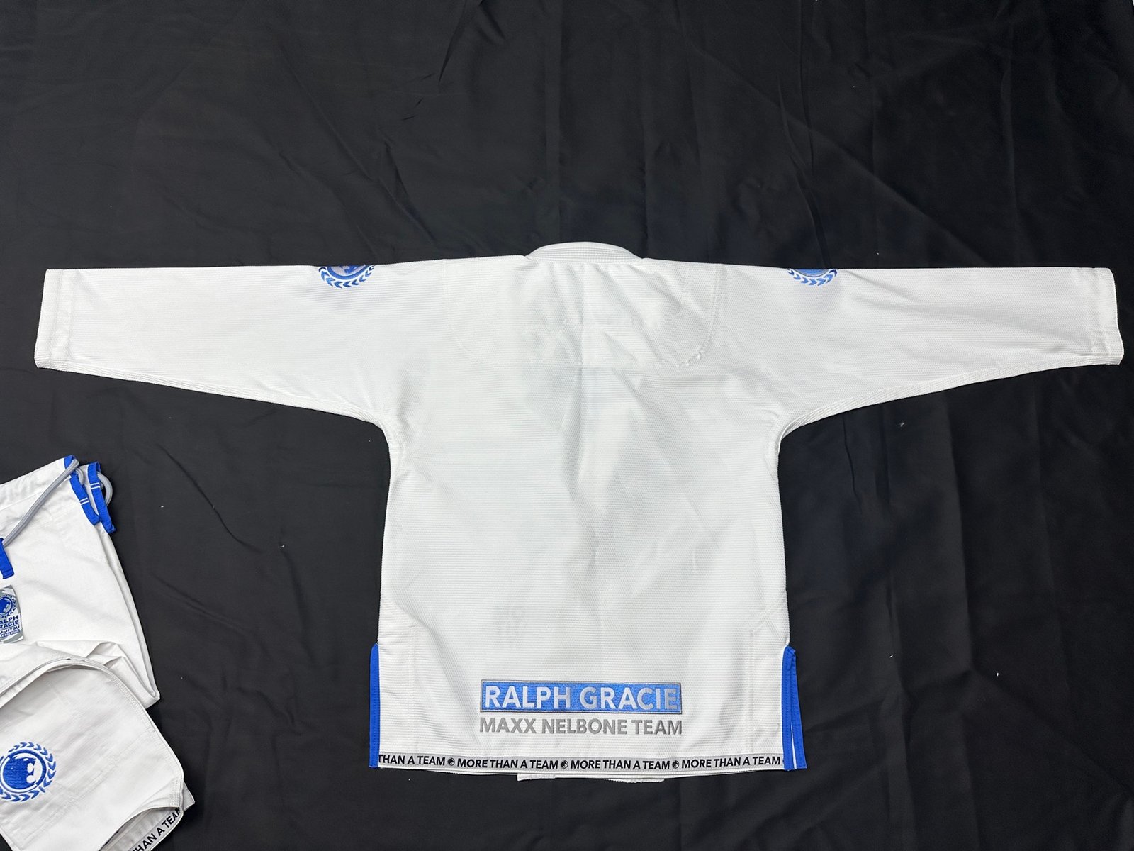 Custom white Brazilian jiu-jitsu gi with team branding manufactured by Special Sporting